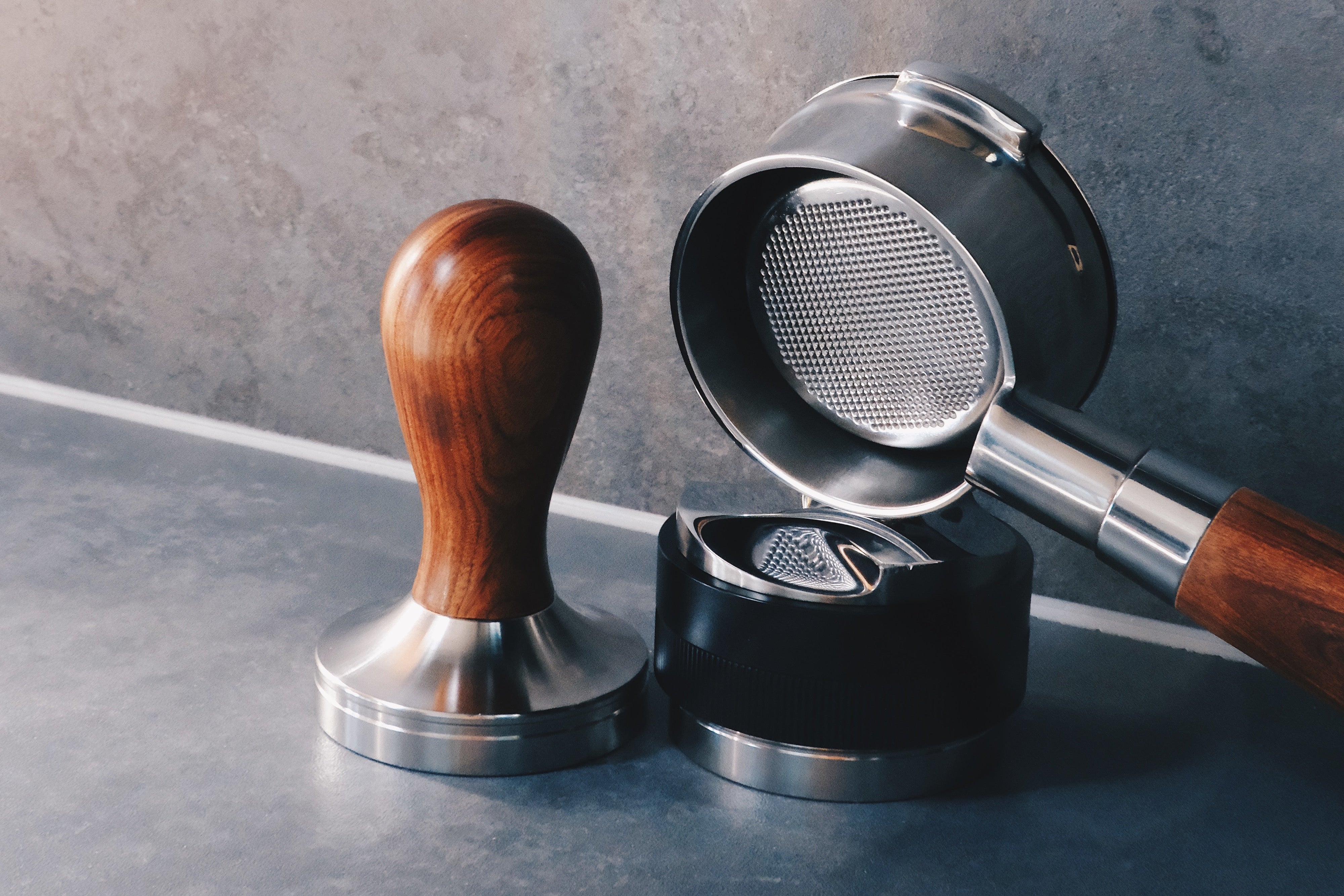 Coffee tamper, distributor and portafilter on espresso bench