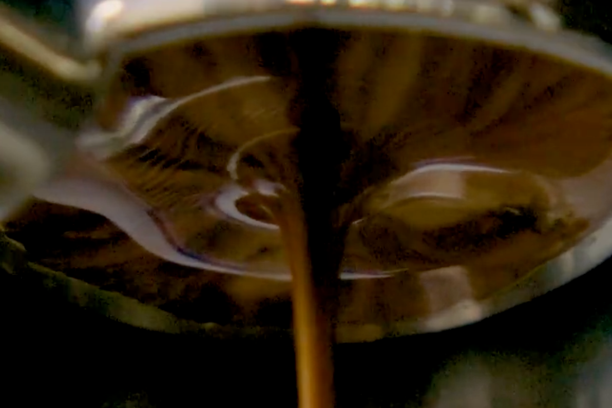 Bottomless portafilter showing espresso extraction